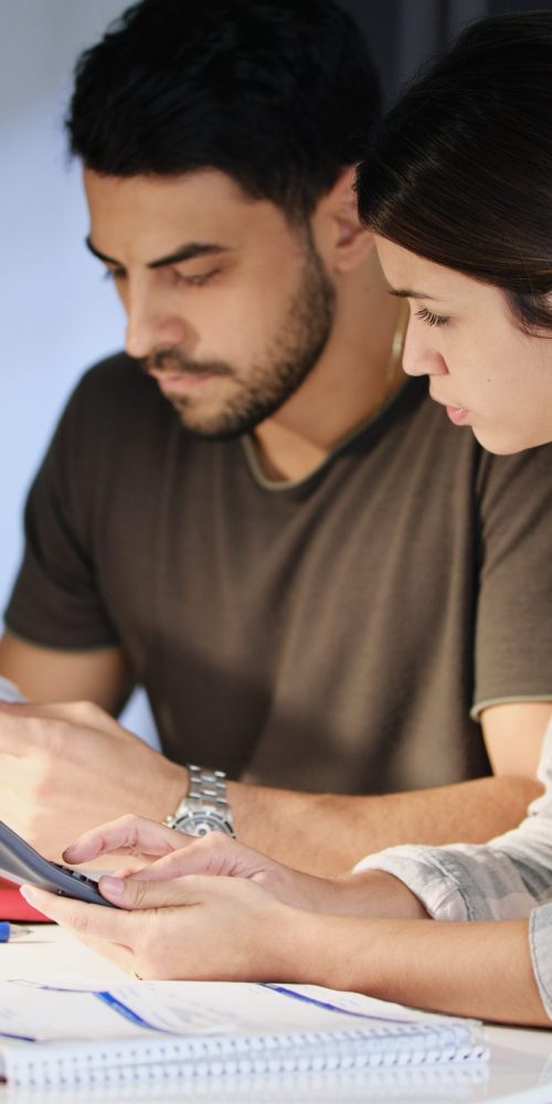 Man and woman concerned about debts and contemplating a debt management strategy